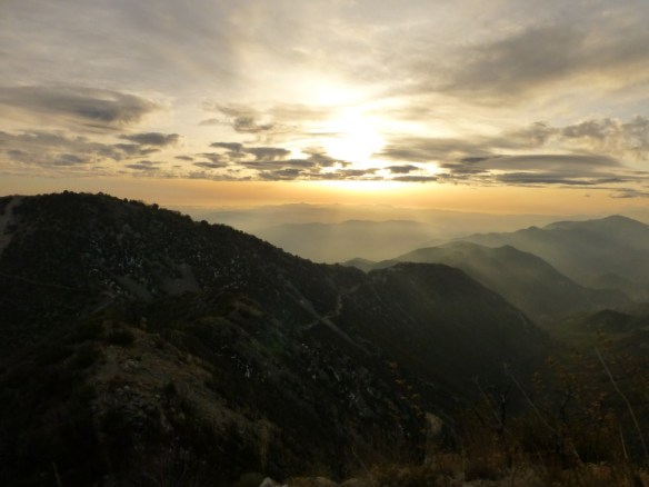 View of the sun breaking through the clouds part way up the Mt. Markham Trail.