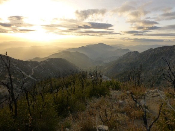 The sun making it below the clouds lighting up the trail.